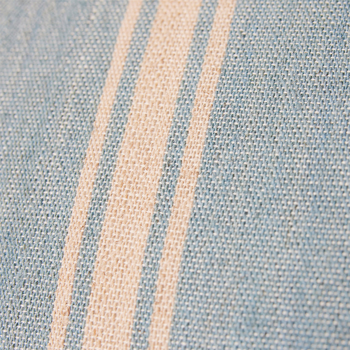 close up of double sided hand woven pillow in soft blue and light brown