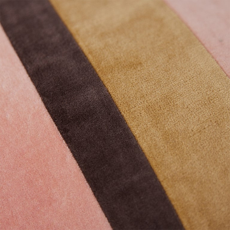 detail of striped velvet lumbar pillow in caramel and pink tones