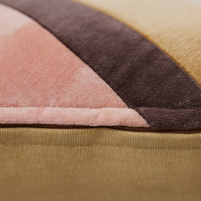 detail of striped velvet lumbar pillow in caramel and pink tones