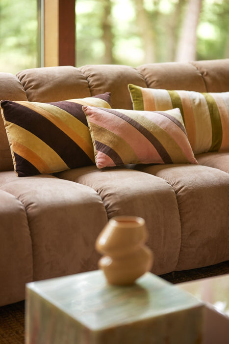 striped velvet lumbar pillow in caramel and pink tones with other lumbar pillows on sofa
