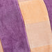 detail of velvet lumbar pillow with peach, pink and purple stripes 