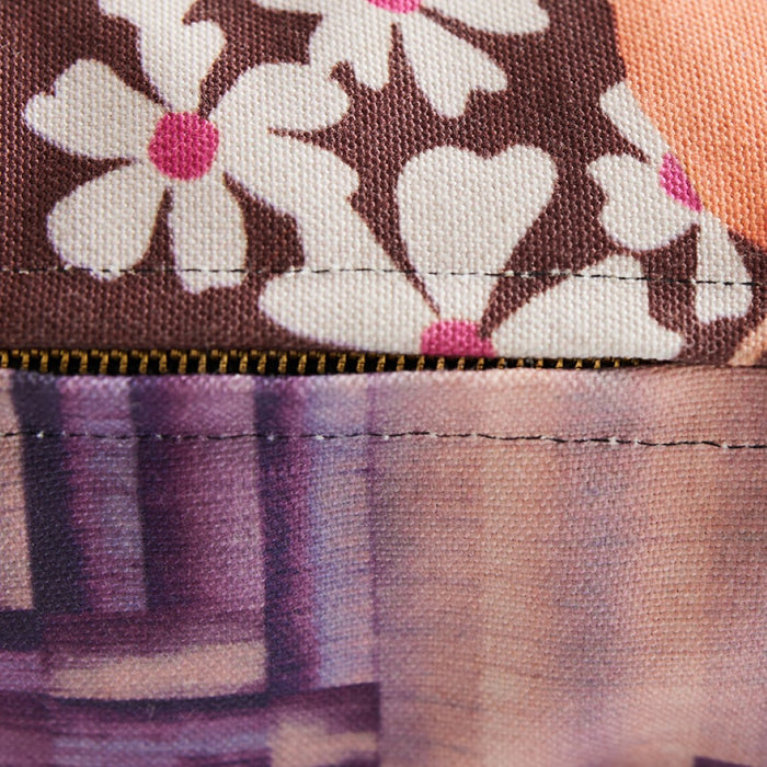detail of double sided lumbar pillow with retro print in purple peach and brown