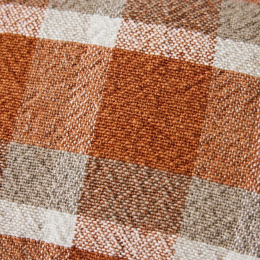 close up of brown gray and white checkered lumbar pillow