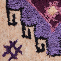 detail of large cotton bohemian style bat rug with purple hues