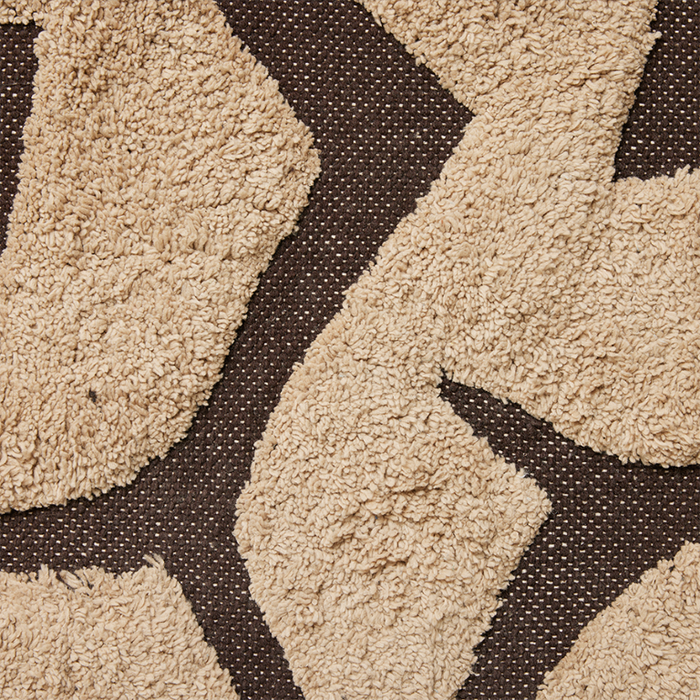 detail of light and dark brown colored bath room rug