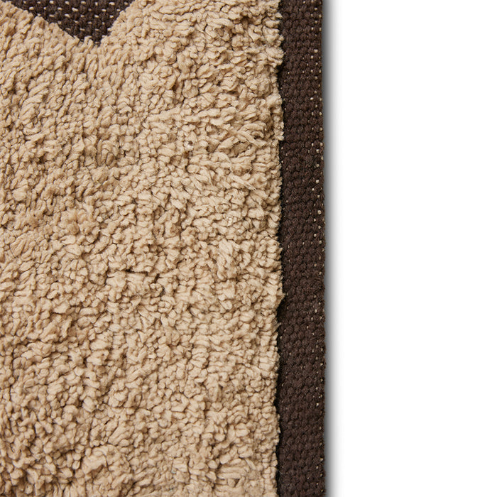 detail of light and dark brown colored bath room rug