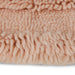 detail of round soft pink colored woolen rug