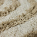round bath mat with high and low pile and cream and beige color