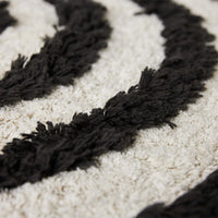 close up round black and white bathroom rug