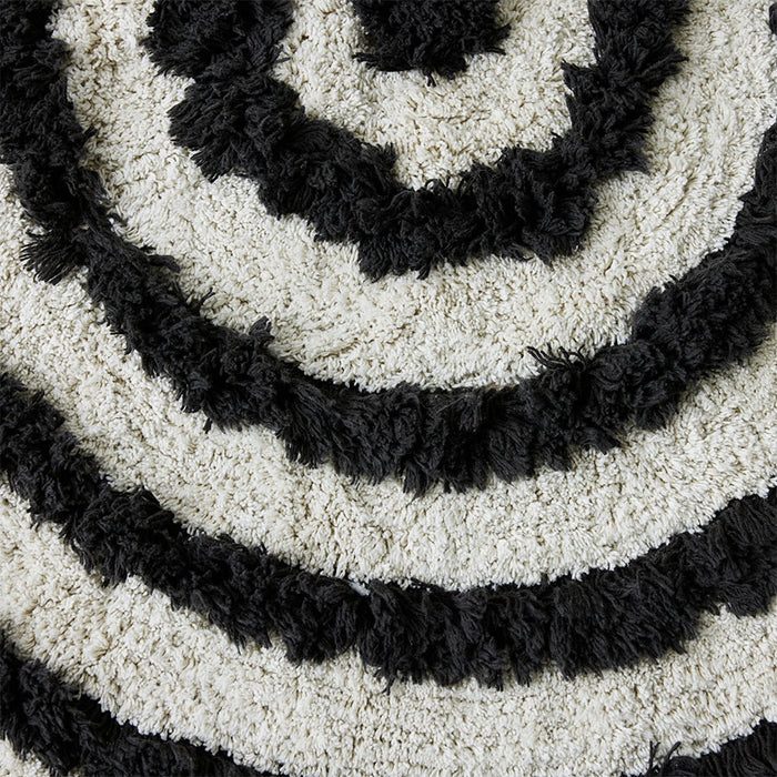 close up round black and white bathroom rug