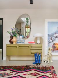 cream colored table lamp on sideboard in living room