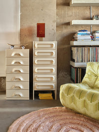 smokey brown and brass corner tale  lamp on cream colored dresser