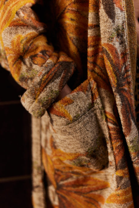 detail of pocket on bathrobe with pockets and orange brown palm tree motive