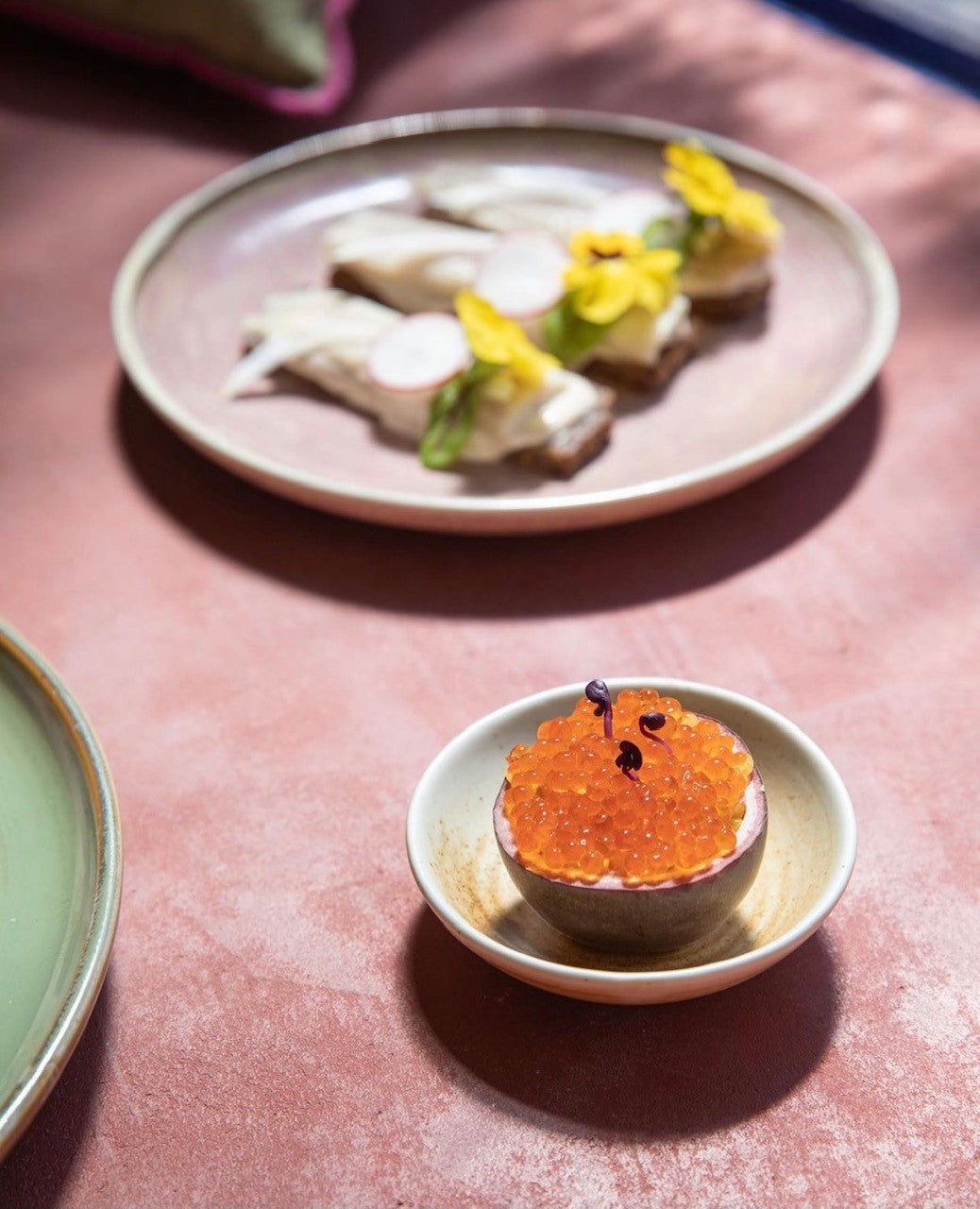 rustic pink dinner plate on table setting with food