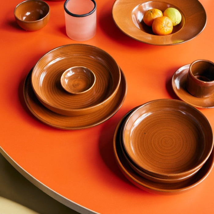 deep plates in retro style burned orange on orange table