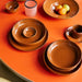 retro style dinnerware on orange table