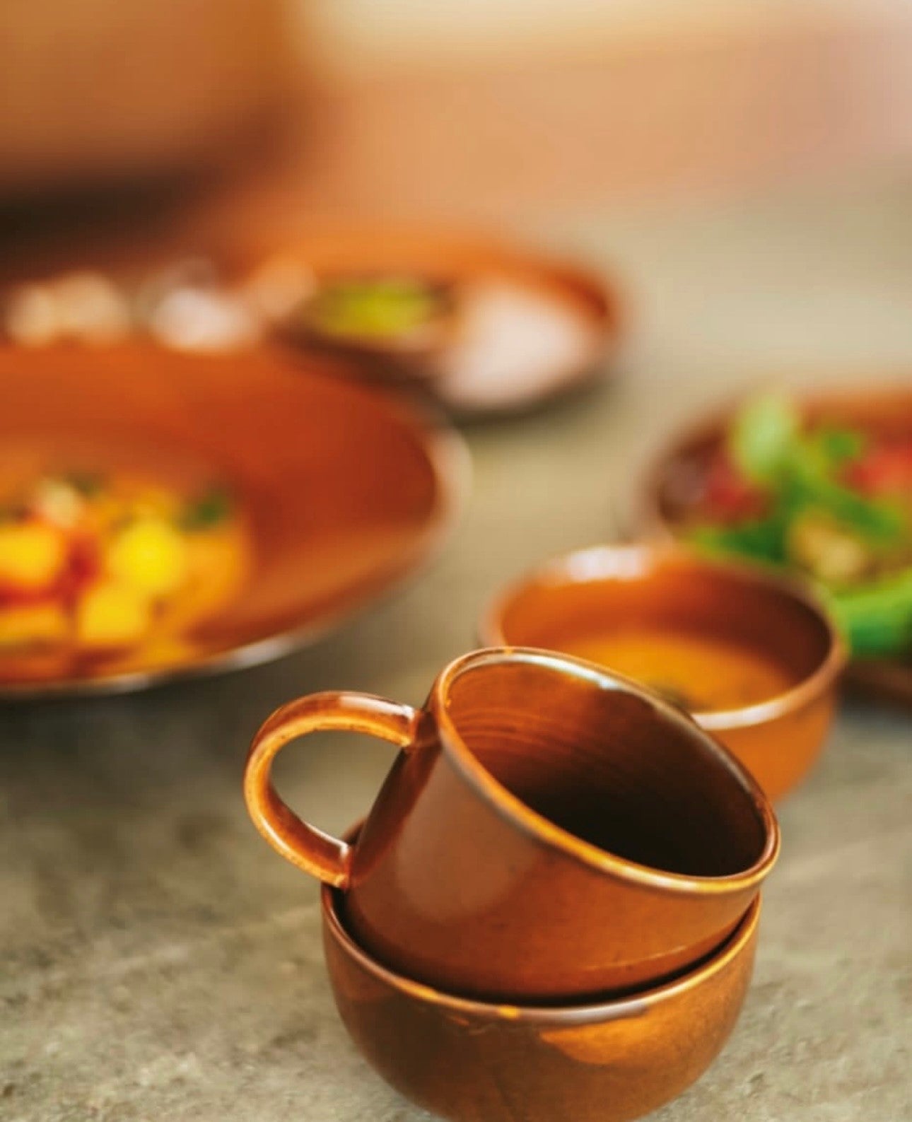 orange brown ceramic mug with ear