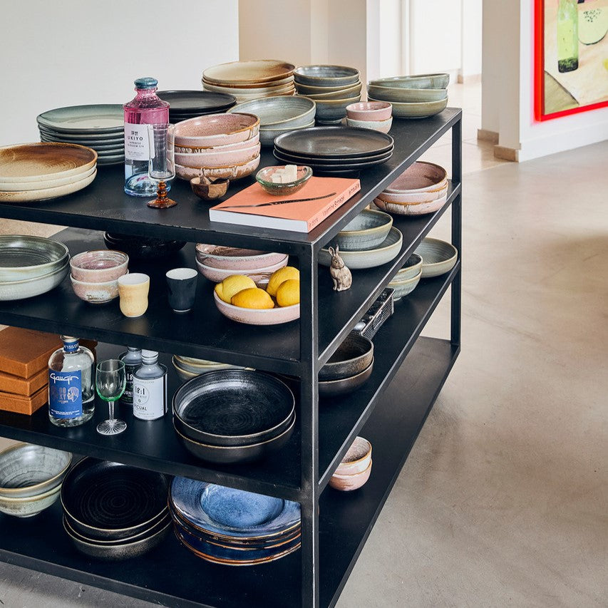 black open kitchen island filled with home chef ceramics and kitchen gear