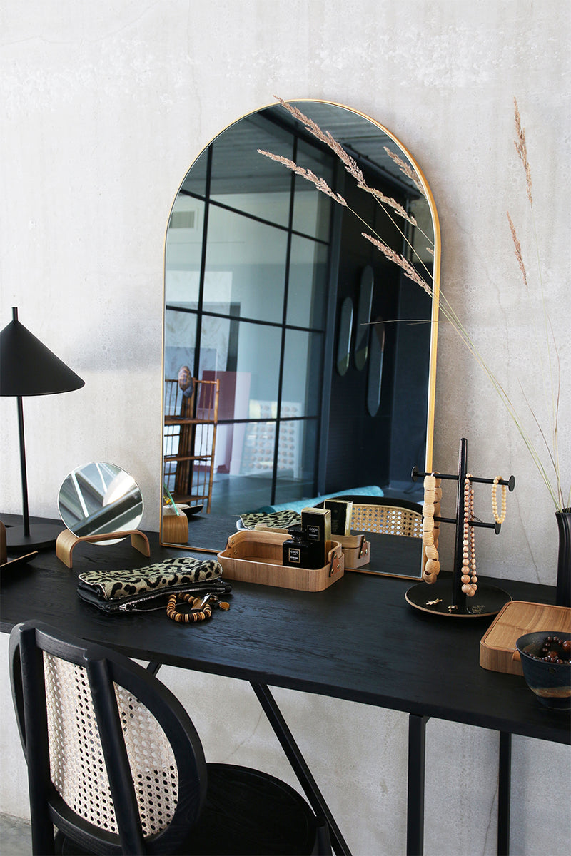 oval shaped brass mirror and willow wood accessories