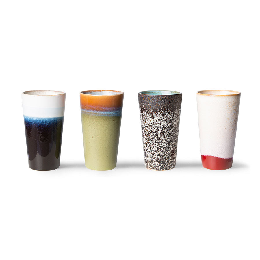 Four ceramic tumblers with multicolored glaze patterns on a white background