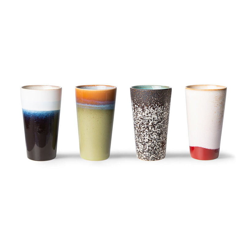 Four ceramic tumblers with multicolored glaze patterns on a white background