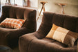 two velvet brown element lounge chairs with pillows