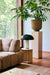 living room with large camel planter with plant on pedestal