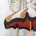 detail of inside of classic striped parasol with black fringes