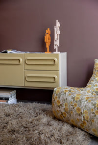 two wooden skyline sculptures in beige and orange on a retro style credenza