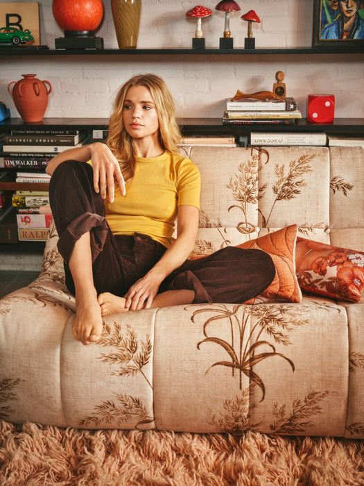 woman with yellow shirt hanging on a lazy lounge sofa bench with classic ivory and brown Reeds fabric