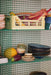 open shelving with chef ceramics and produce in plastic crates