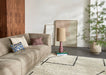 taupe colored linen blend element sofa with abstract painting and floor lamp with purple base