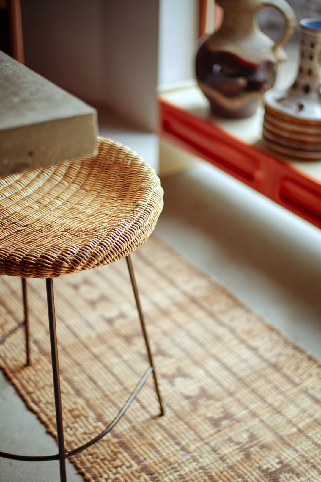 black iron and natural wicker counter stool