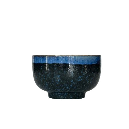 Black ceramic bowl with blue interior on a white background