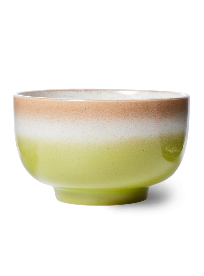 Green ceramic bowl with a brown rim on a white background