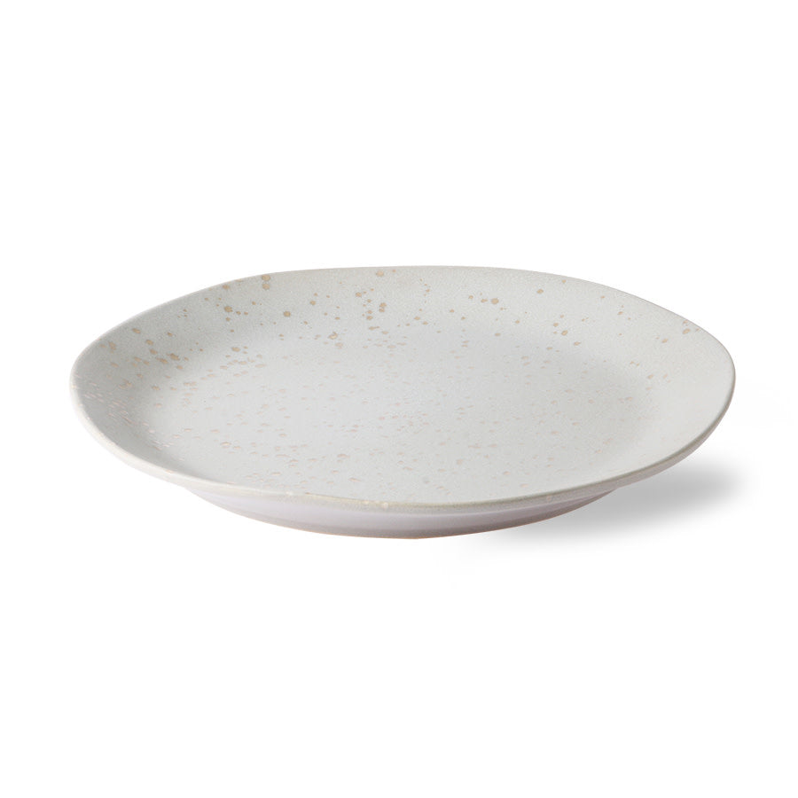 White ceramic plate with speckled texture on a white background