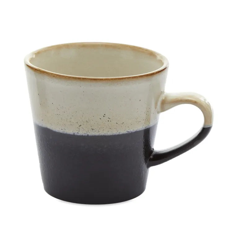 Two-toned ceramic mug with beige top and black bottom on a white background
