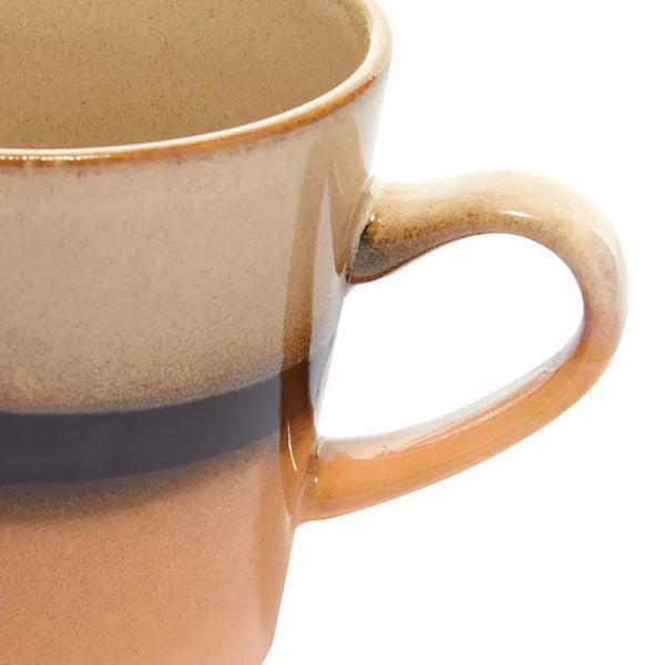 Close-up of a ceramic mug with a handle on a white background