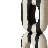 Black and white striped decorative object on a white background
