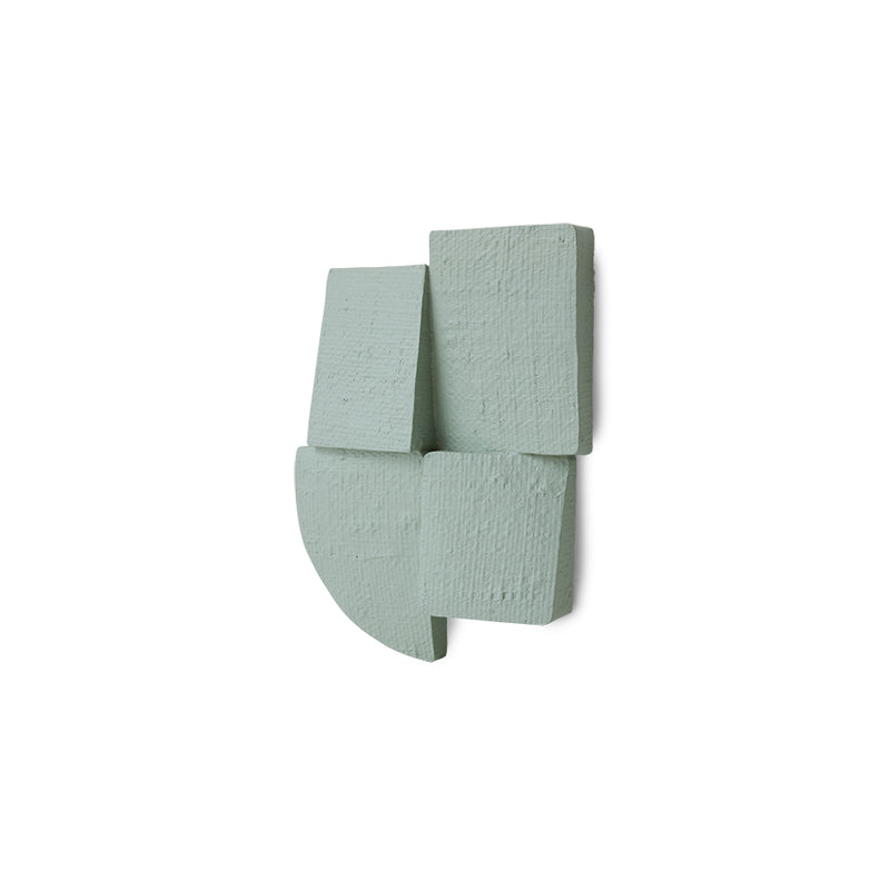 green textured wall sculpture on a white background