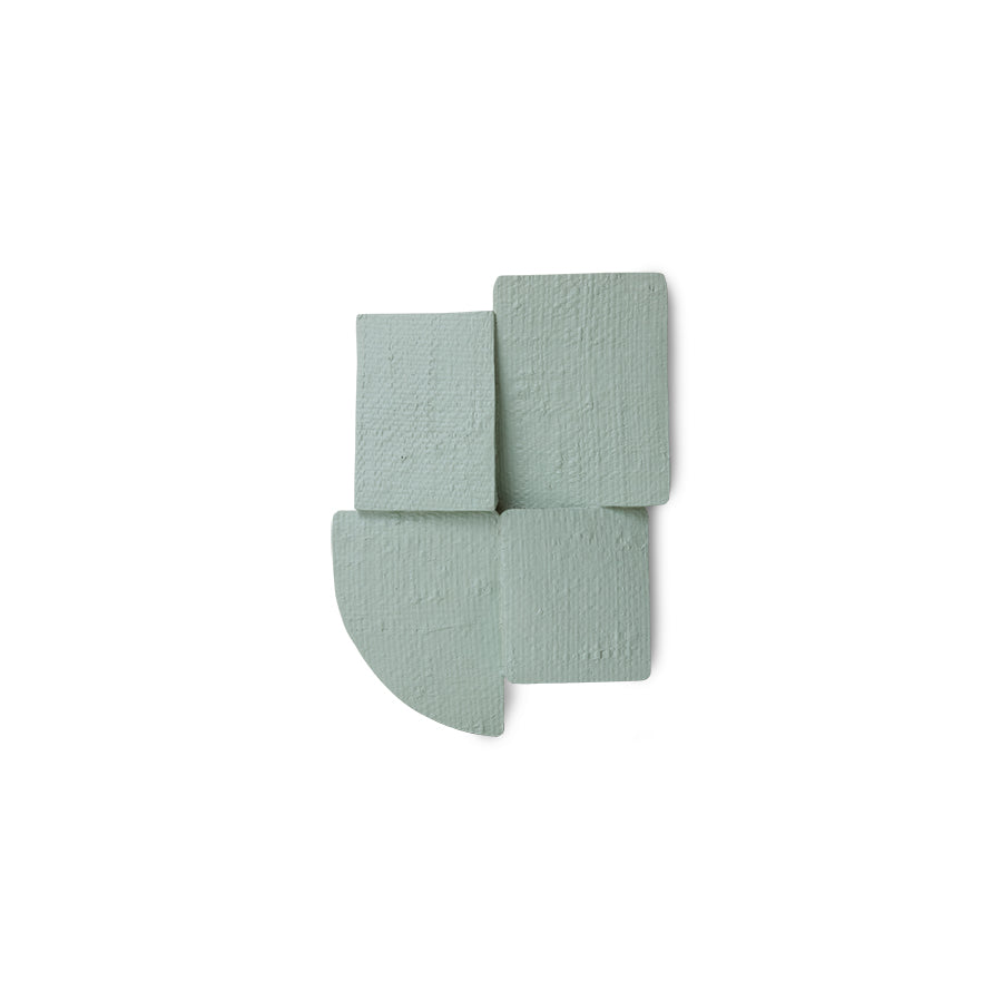 green textured wall sculpture on a white background