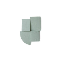 green textured wall sculpture on a white background