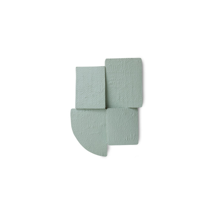 green textured wall sculpture on a white background