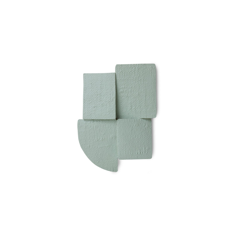 green textured wall sculpture on a white background