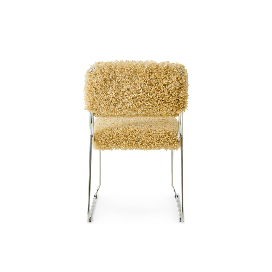 Chair with beige fluffy cushion on a white background