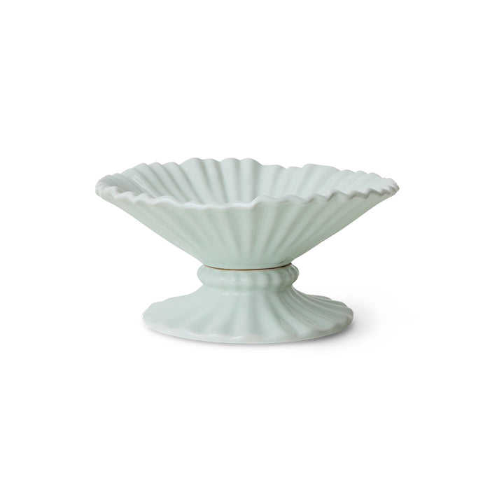 Light blue ceramic bowl with scalloped edge on a white background