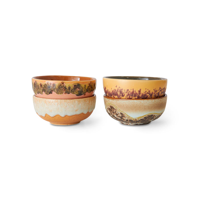 Set of four ceramic bowls with earthy tones on a white background