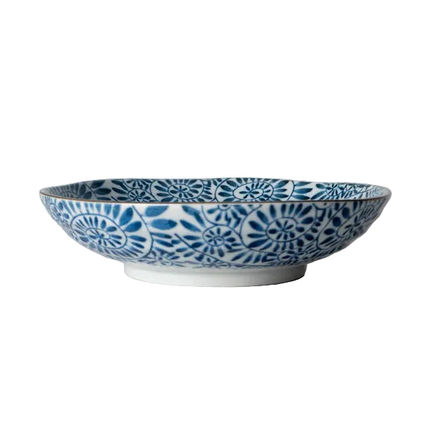 Ceramic bowl with blue floral pattern on a marble surface