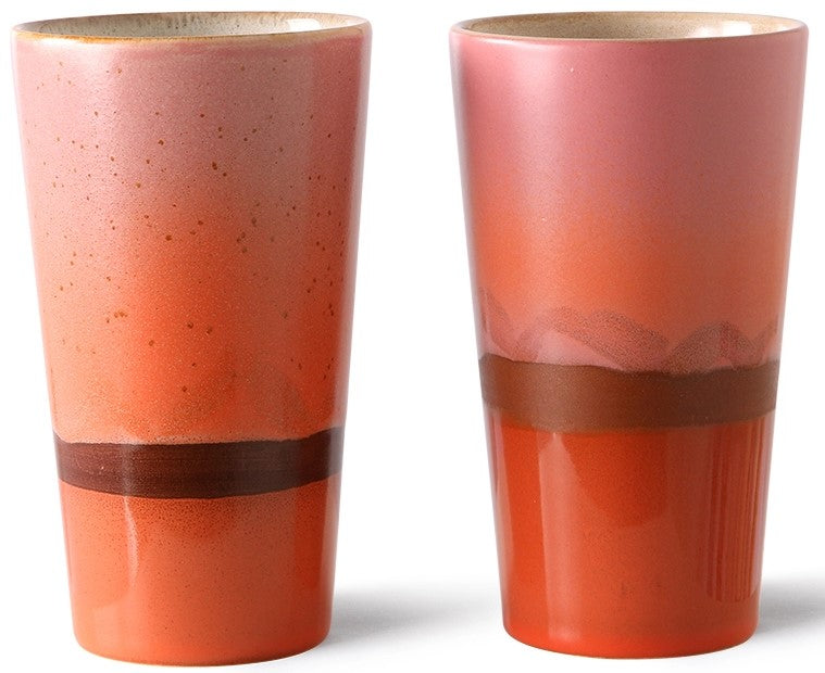 Two ceramic tumblers with a gradient color design on a white background