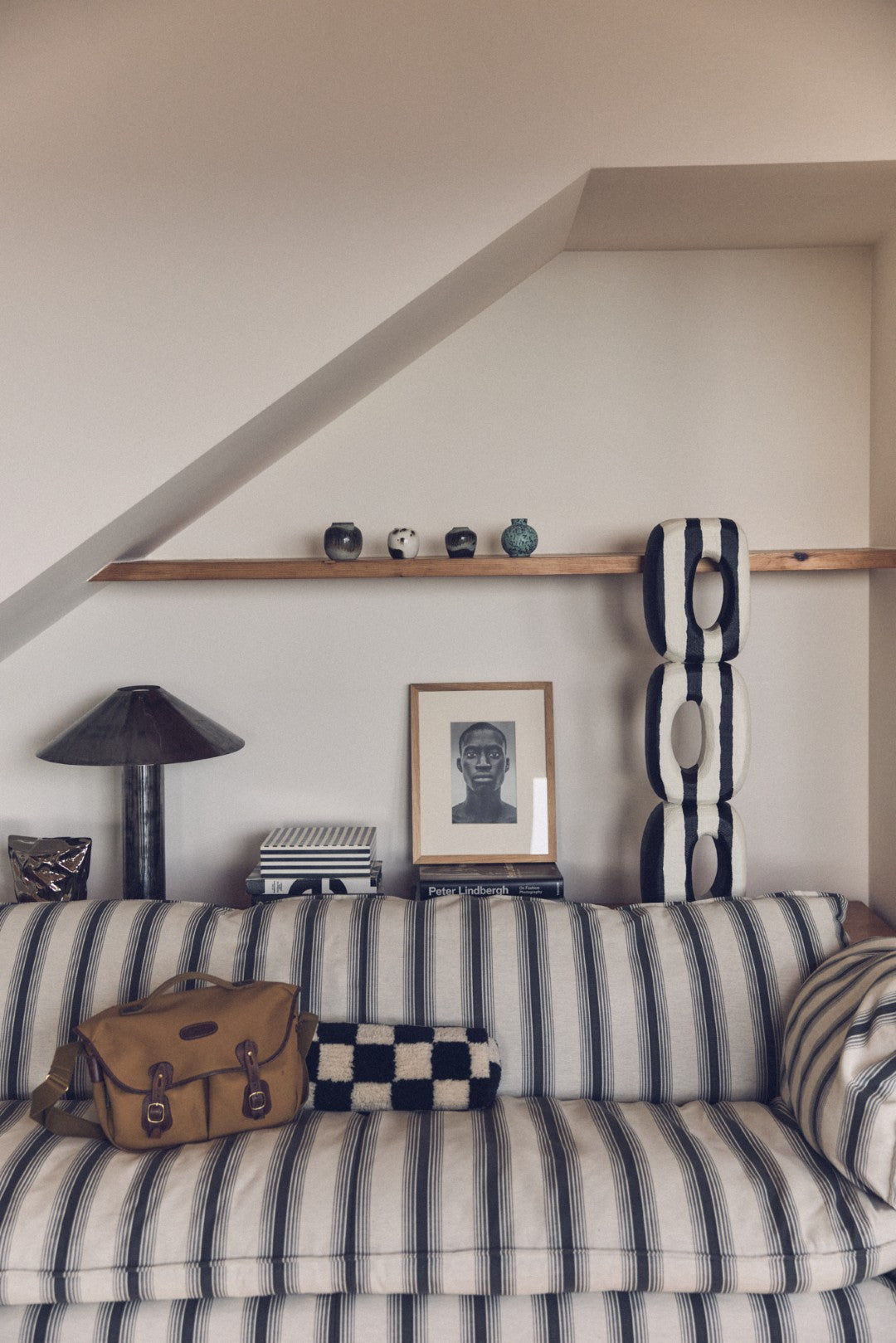 Striped sofa with decorative items against a white wall